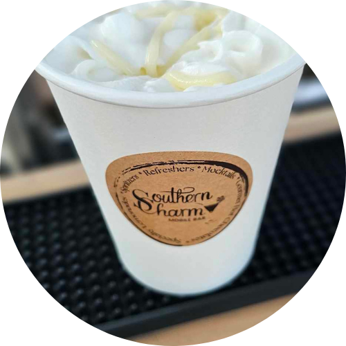 Delicious hot chocolate topped with whipped cream, served in a custom-branded Southern Charm Mobile Bar cup, showcasing their handcrafted beverages for events in Floral City, FL.